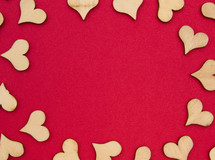 wooden heart cutouts on red 