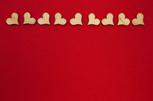 wood heart cutouts on red 