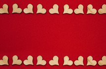 red background and wooden heart cutouts border 