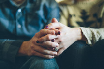 couple holding hands in prayer 