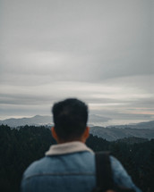 a man looking out over mountains 