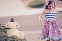a little girl walking down a sidewalk 