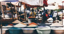 grains and spices in an outdoor market 