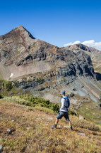 a man hiking up a mountainside 
