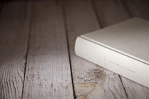 white Bible on wood 