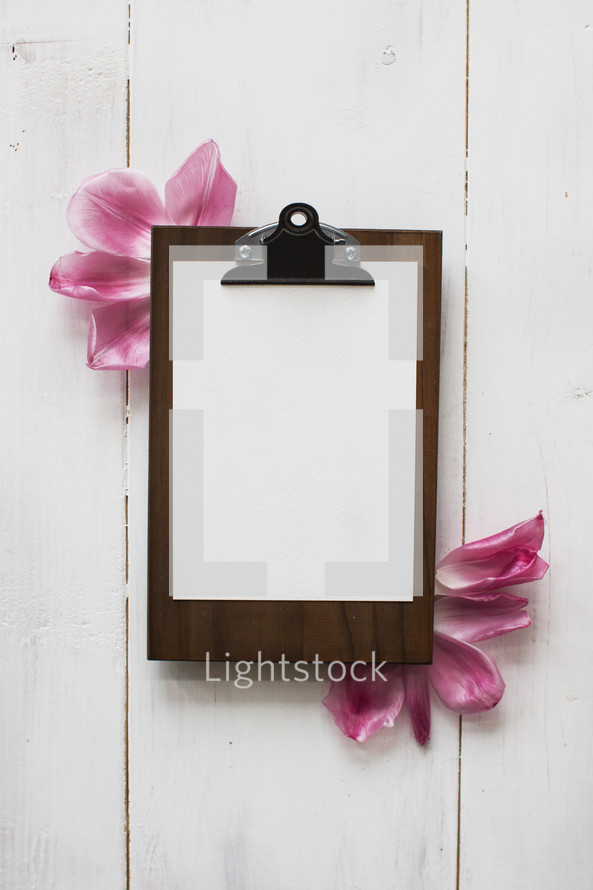 clipboard and flower petals