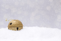 gold bell in snow 