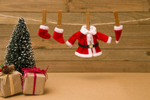Christmas stockings and Santa suit on a clothesline 