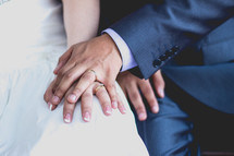 a bride and groom holding hands 