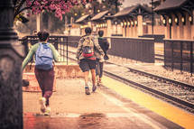 Children running to catch a train. 