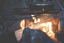 a pot on a campfire 