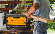 a man sawing a wood board 