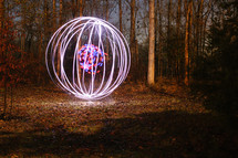 glowing ball of light in a forest 