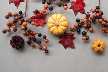 Festive autumn decor with pumpkin, berries and leaves