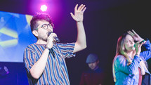 worship leaders on stage with a microphone 