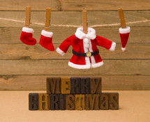 Santa suit and Christmas stockings on a clothesline 