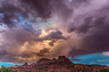 clouds over red rock peaks at sunset 