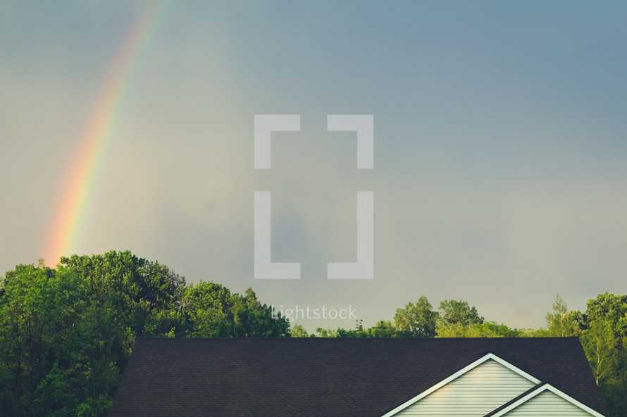 rainbow in the sky over a roof 