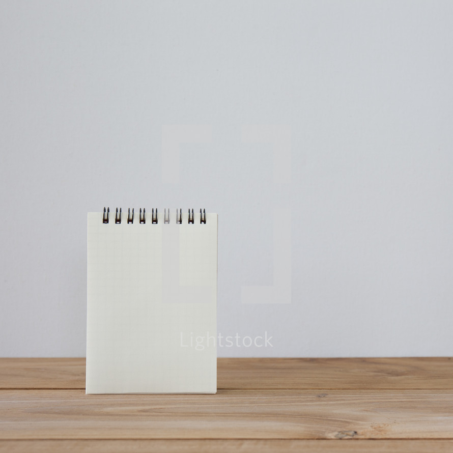 notepad on a wood desk 