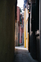 narrow alley between colorful buildings 