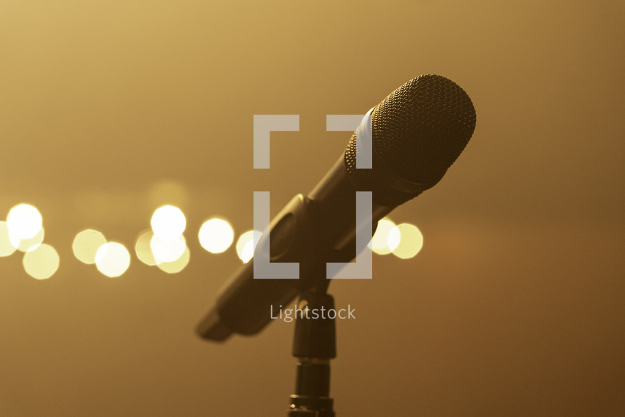 Microphone on stage at a concert, bright lights