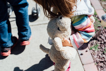 a little girl holding a stuffed animal  