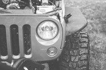 headlights and tires of a Jeep 