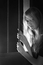 teen girl holding onto bars 
