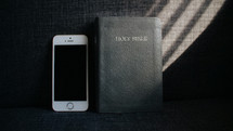iPhone and Bible on a couch 