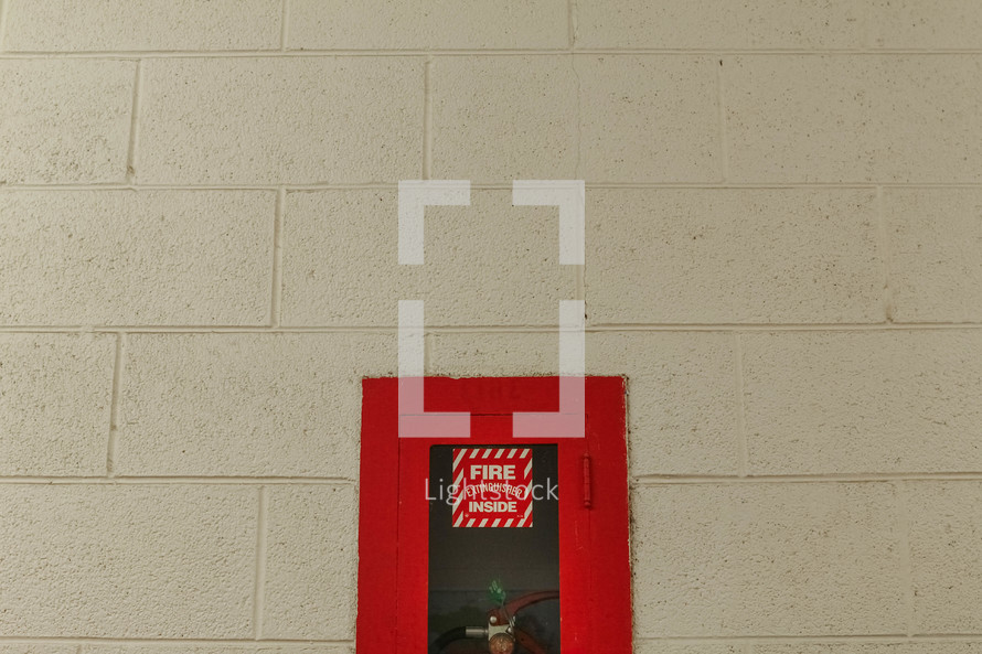 fire extinguisher in a wall cabinet