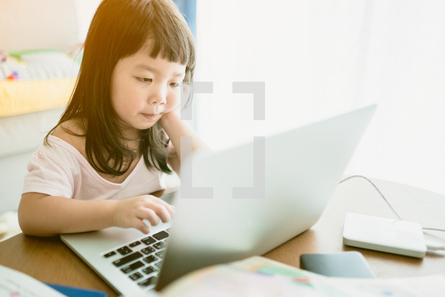 a child learning using a laptop computer 
