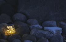 fairy lights in a jar on rock 