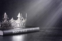 Bible and crown on a wooden background 