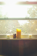 Candles in a window sill.
