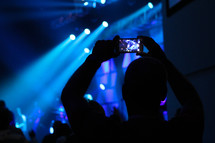 taking a picture with a cellphone at a concert 
