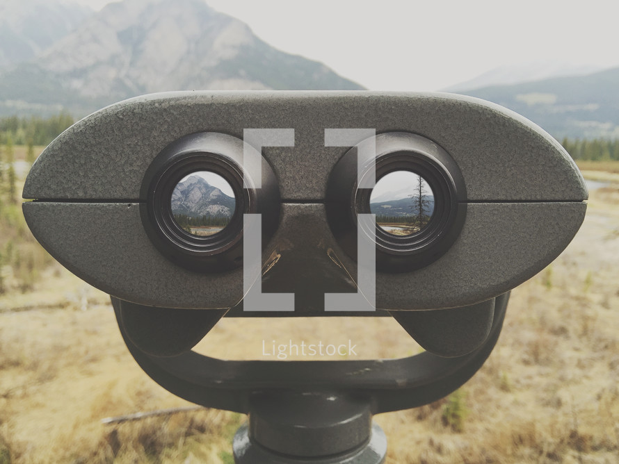 an iPhone capture of look out binoculars in a remote mountain area - with added photos in vision holes