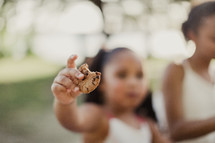 little girl holding a cookie 