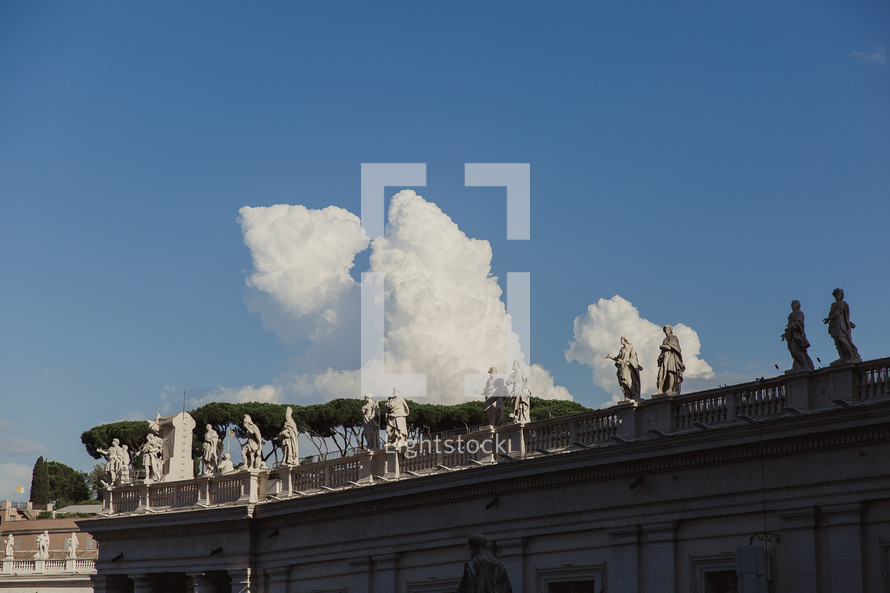 Statues lining the tops of buildings in the Vatican 