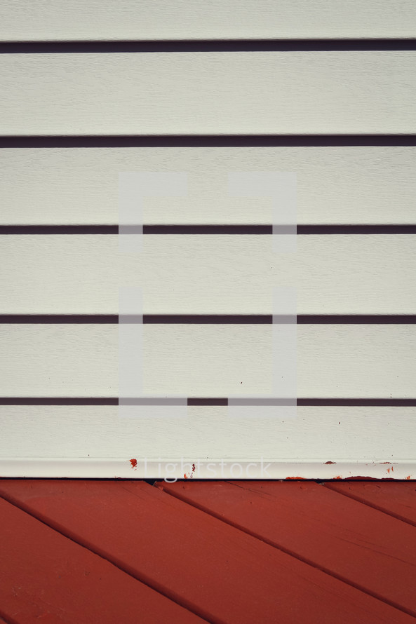 white siding and red decking 