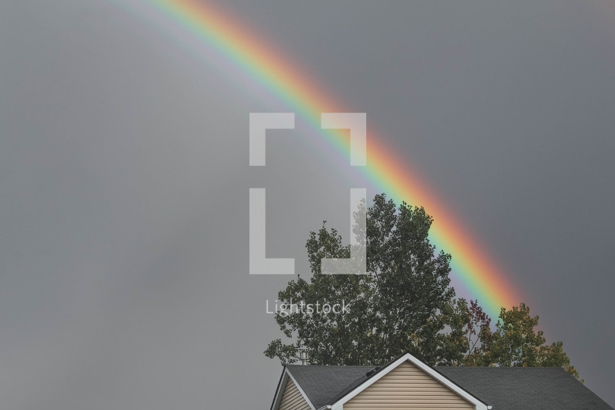 rainbow over a house roof 