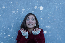 a teen girl catching snow 