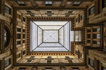 looking up through sky lights in an ornate building 