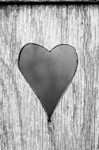 heart cut into wood 