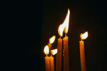 flames on candles in the darkness 