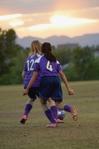 female athletes on a soccer field 