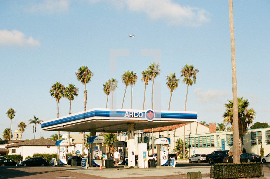 tall palm trees and a gas station 