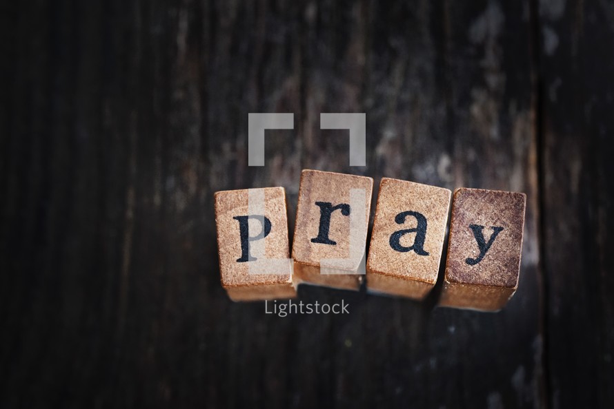 word pray on wood blocks 