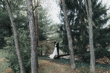 bride and groom kissing in a forest 