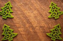 green felt Christmas trees border on wood 