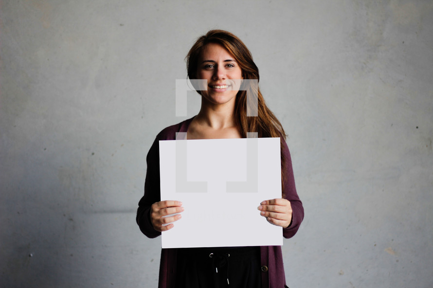 a woman holding a blank piece of paper 